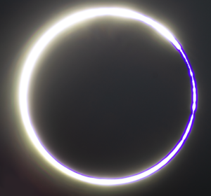 As the circular Moon blocks less of the Sun’s bright light, the Sun’s fiery ring of light slowly transforms into a bright crescent or C-shape. In this image, Baily’s Beads appear like glowing pearls at both ends of the Sun’s glowing crescent.
