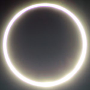 The Moon appears as a smooth black disk that blocks the center of the Sun. As a result, the Sun appears to be a very bright ring of fire, glowing around the Moon’s circular edge.